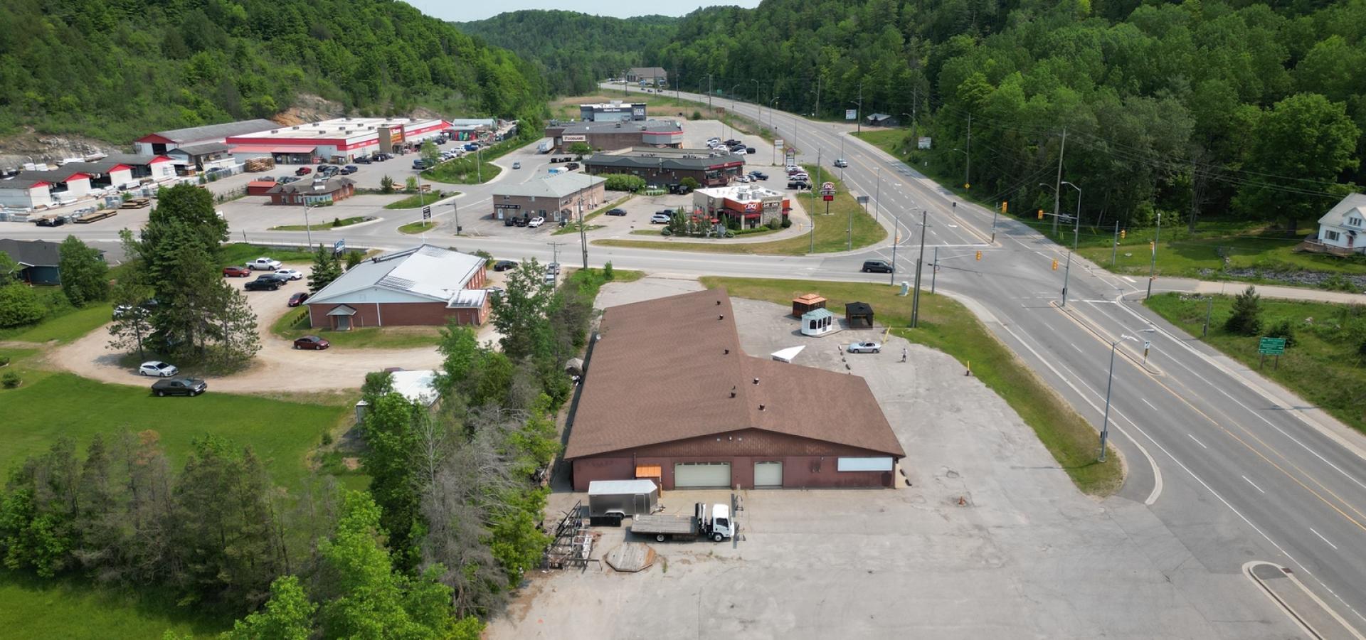 Arial view of large commercial bulding showing parking lot and proximity to roads