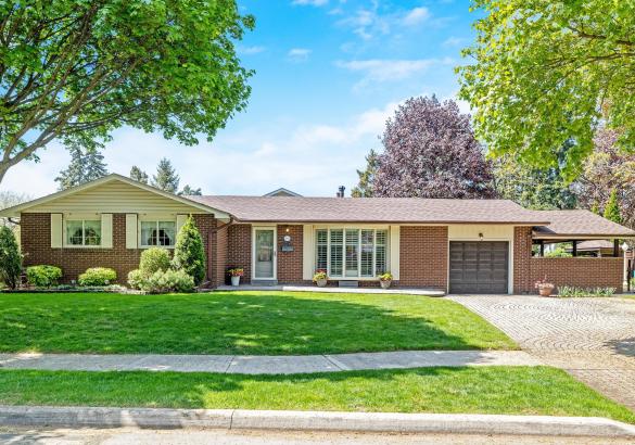 Beautiful brick bungalow with great curb appeal, surrounded by mature trees